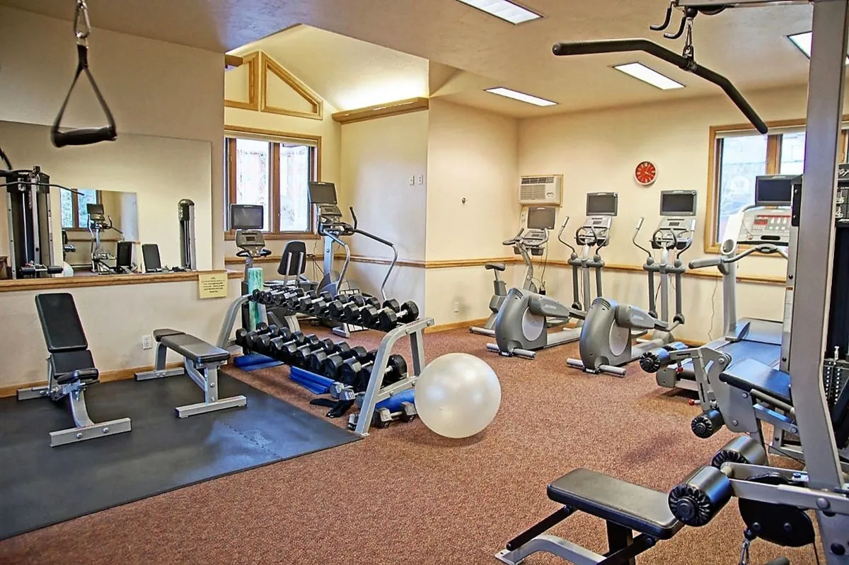 A well-equipped fitness center featuring weightlifting equipment, treadmills, and exercise balls. The bright, energetic space encourages active pursuits and caters to guests’ wellness routines.